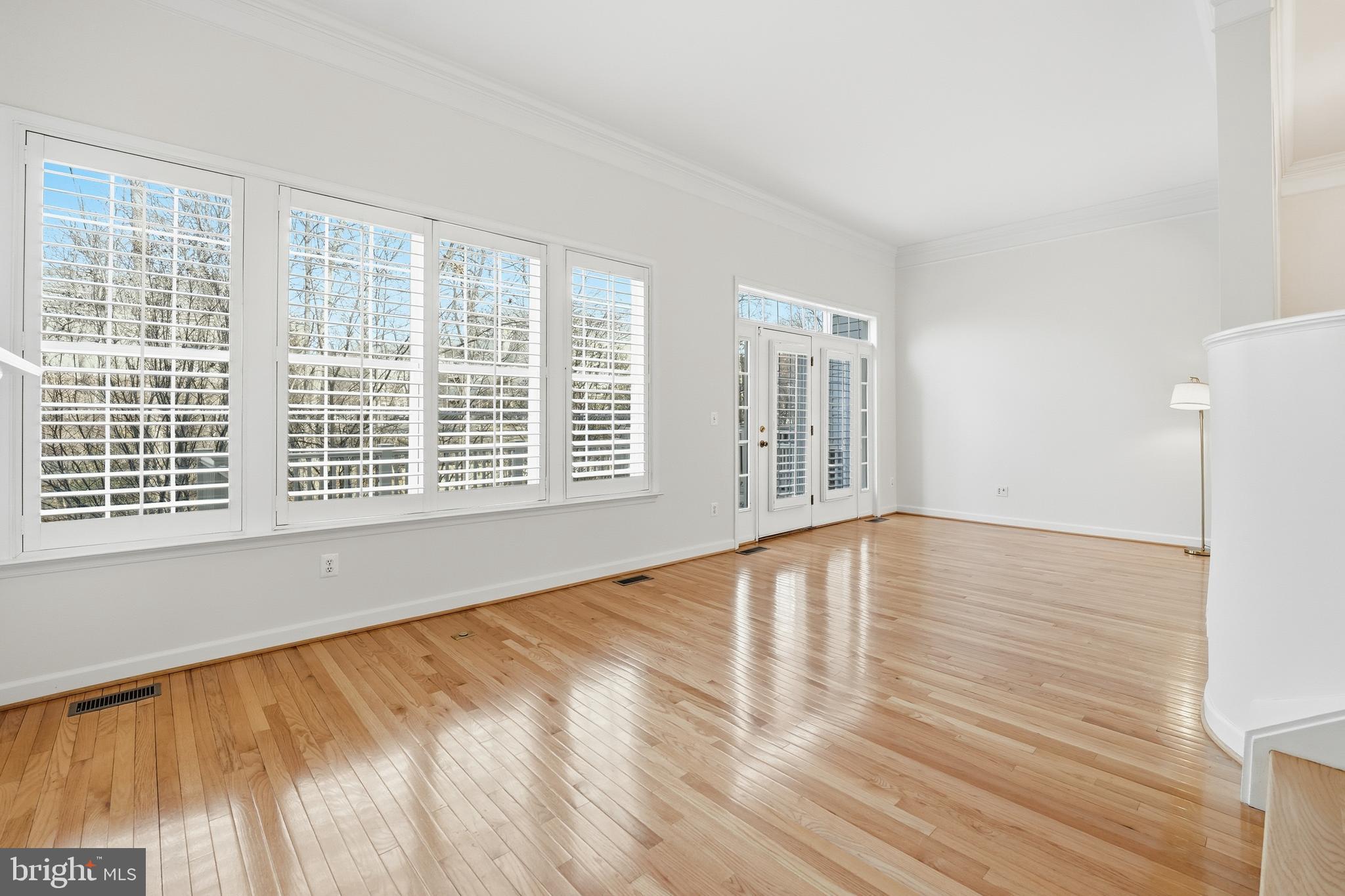 1919 Logan Manor Drive Reston, VA 20190 - Photo 3 of 54 a view of an empty room with wooden floor and a window
