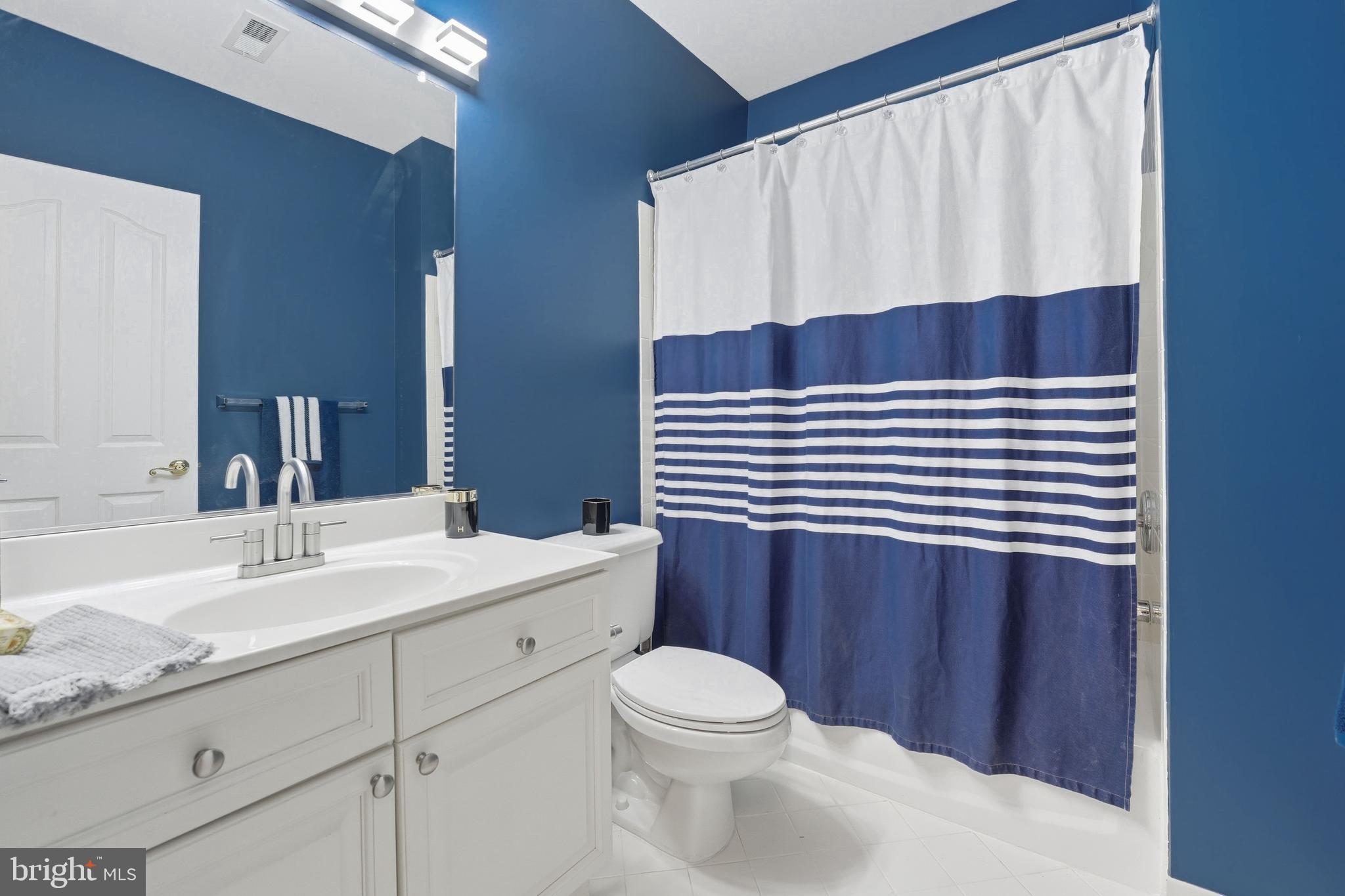 1919 Logan Manor Drive Reston, VA 20190 - Photo 38 of 54 a bathroom with a sink a toilet and shower curtain