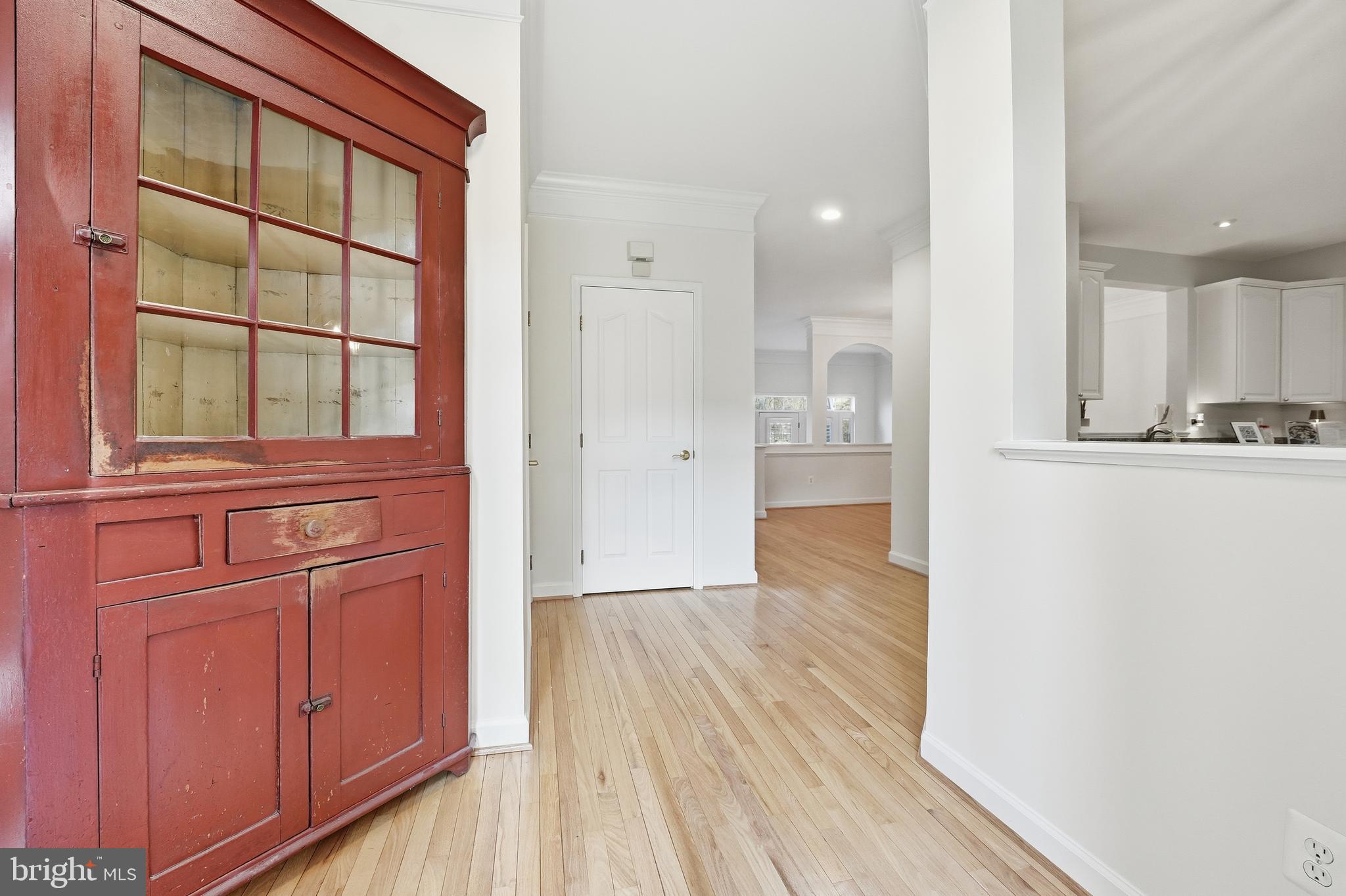 1919 Logan Manor Drive Reston, VA 20190 - Photo 52 of 54 a view of a hallway with wooden floor and cabinet