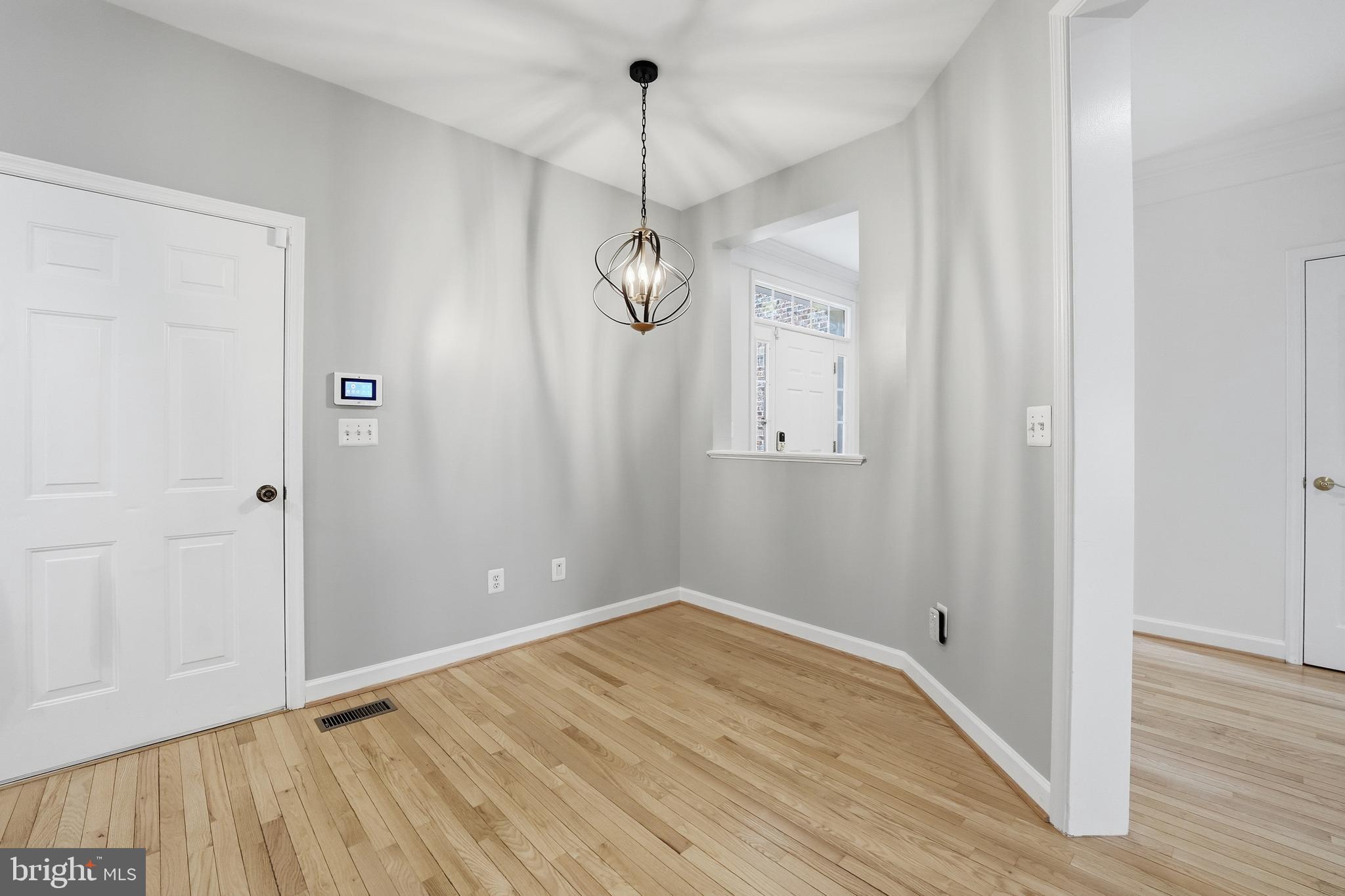 1919 Logan Manor Drive Reston, VA 20190 - Photo 10 of 54 a view of a room with wooden floor and white walls
