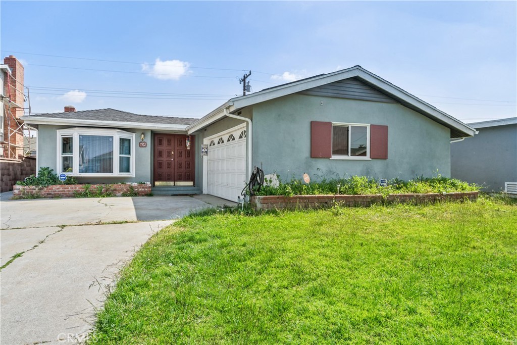 a front view of house with yard and green space