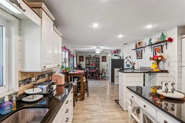 a kitchen with stainless steel appliances granite countertop a sink and cabinets