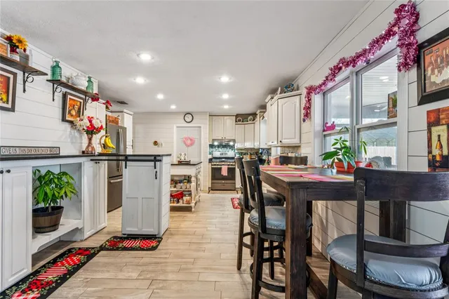 a living room with furniture a rug and a flat screen tv