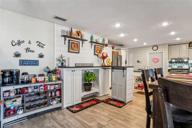 a living room with furniture workspace and a flat screen tv