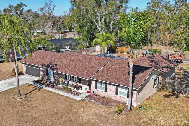 a view of a patio with table and chairs with wooden fence and plants