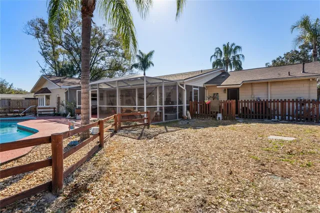 a view of a house with a yard and sitting area