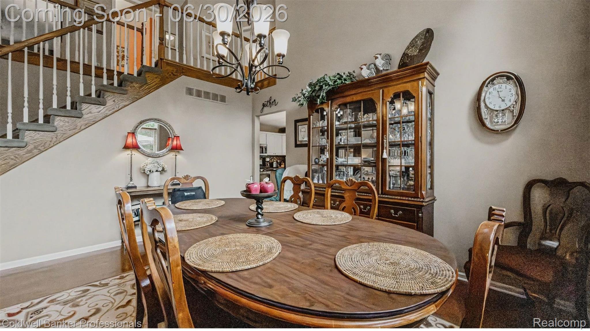 1085 Bloomview Circle Rochester, MI 48307 - Photo 20 of 67 Open-concept dining area featuring a wood-finish oval table, chandelier lighting, and a staircase with white balusters