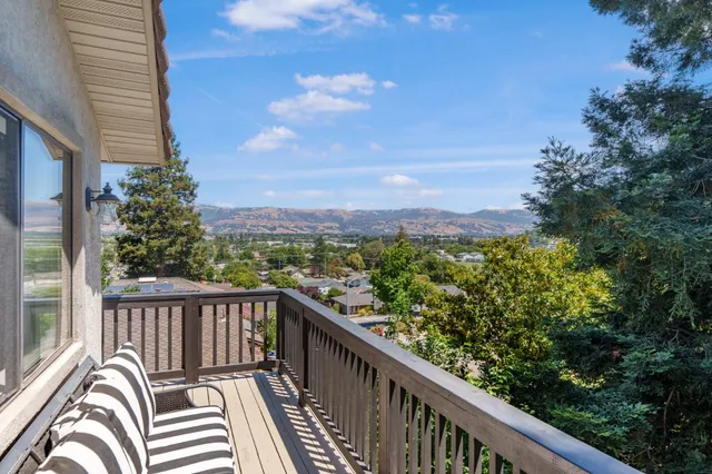 a view of a balcony with wooden floor and fence