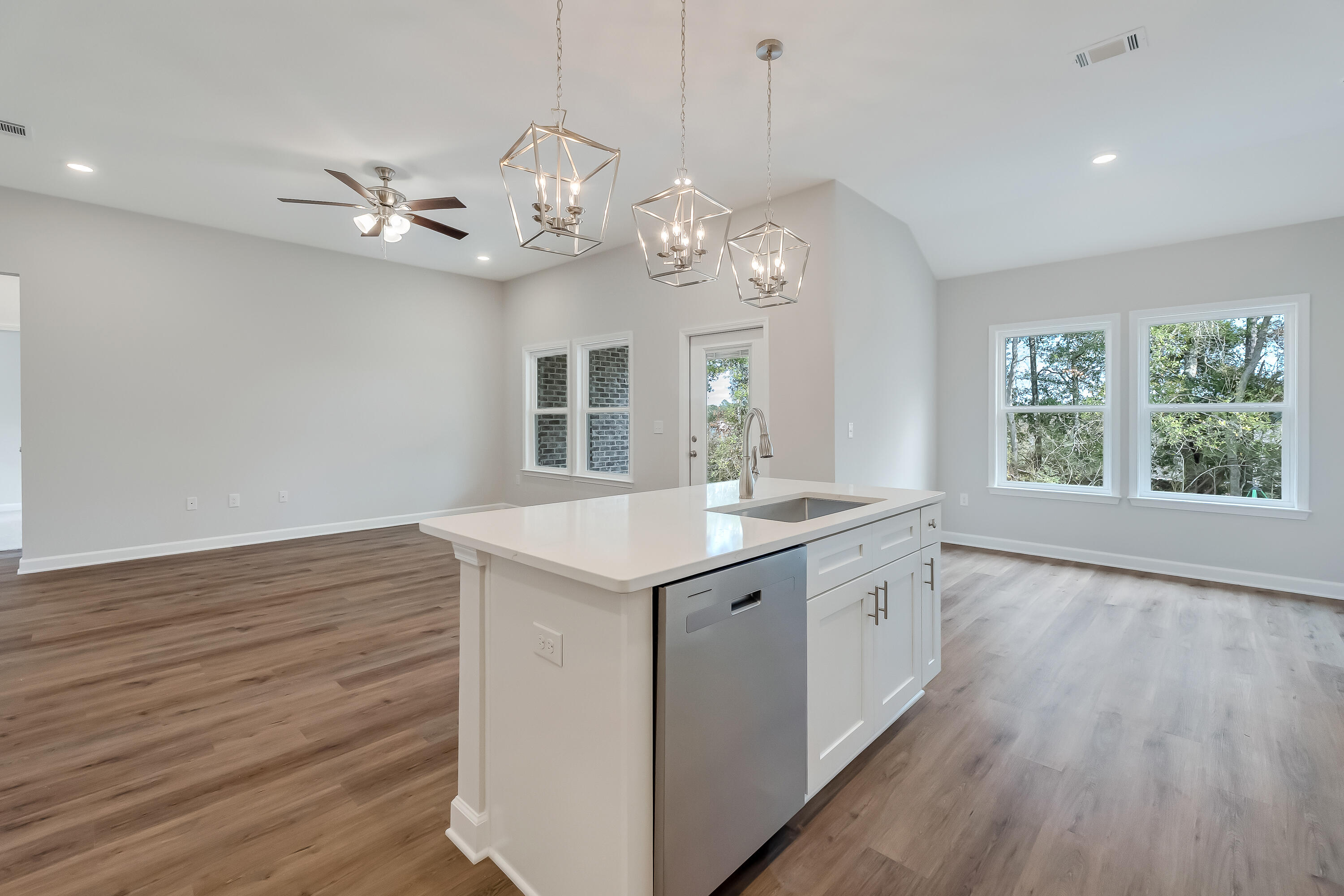 106 Huron Trail Crestview, FL 32536 - Photo 19 of 44 a open kitchen with a large window a wooden floor and stainless steel appliances