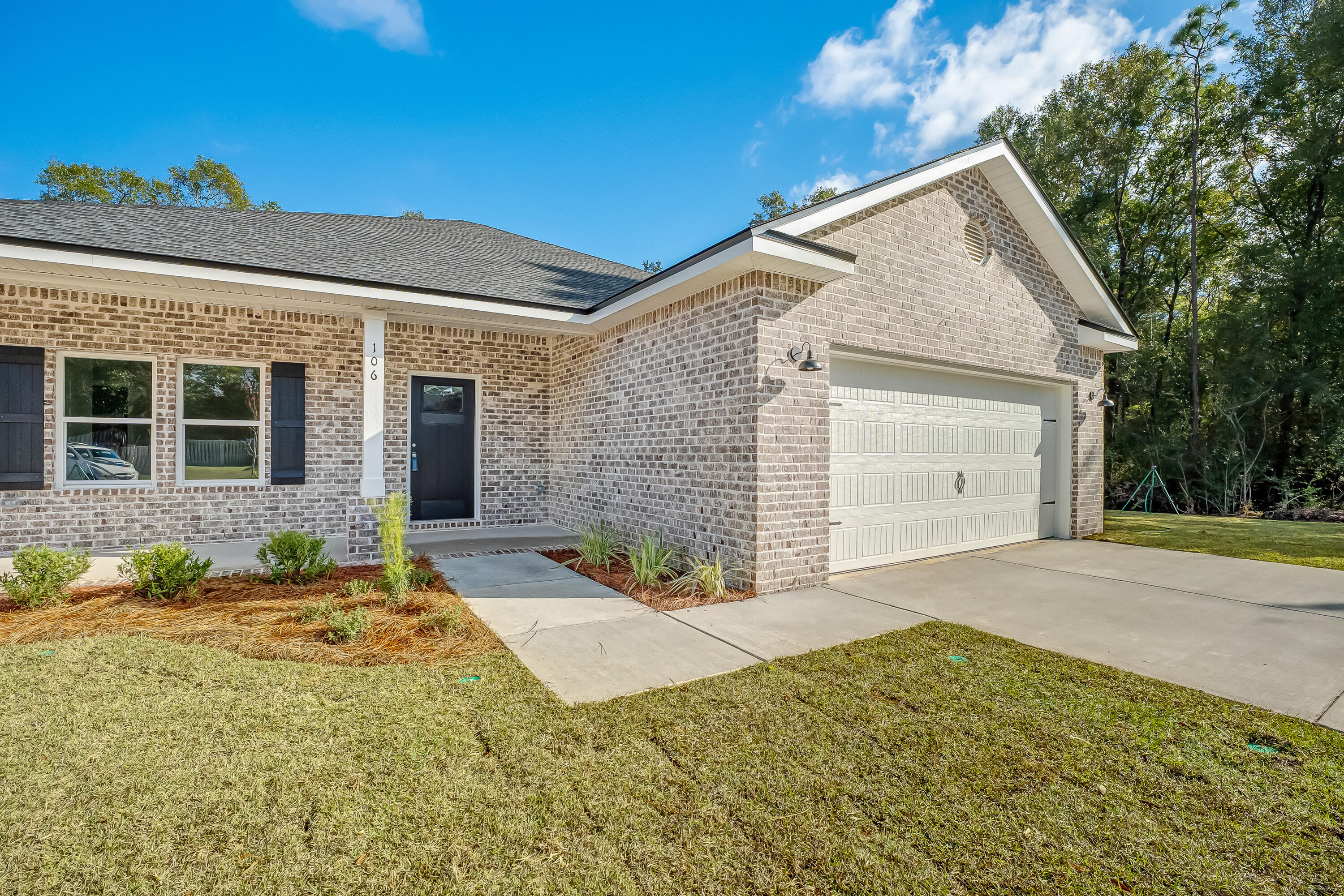106 Huron Trail Crestview, FL 32536 - Photo 2 of 44 a front view of a house with a yard and garage