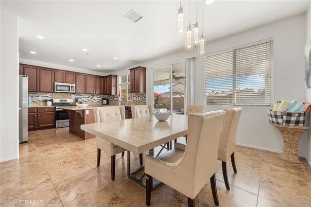 a kitchen with stainless steel appliances granite countertop a stove a sink dishwasher a refrigerator and a oven