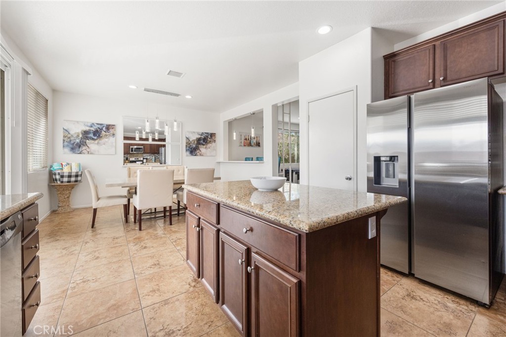 84155 Tramonto Way Indio, CA 92203 - Photo 19 of 38 a kitchen with center island table and chairs