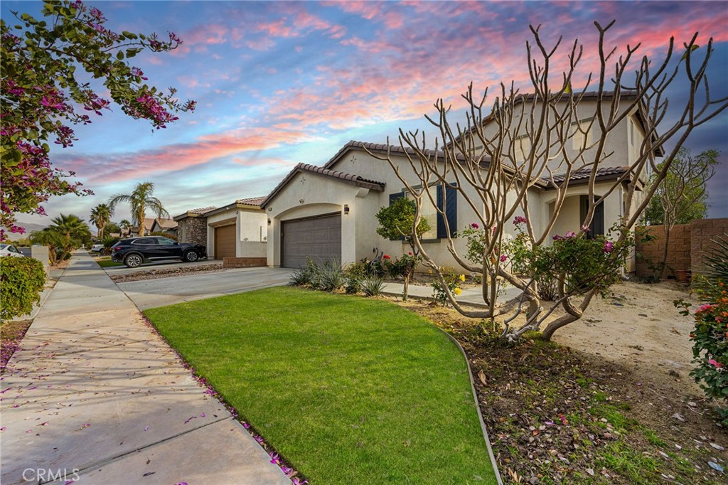 84155 Tramonto Way Indio, CA 92203 - Photo 2 of 38 a front view of a house with garden