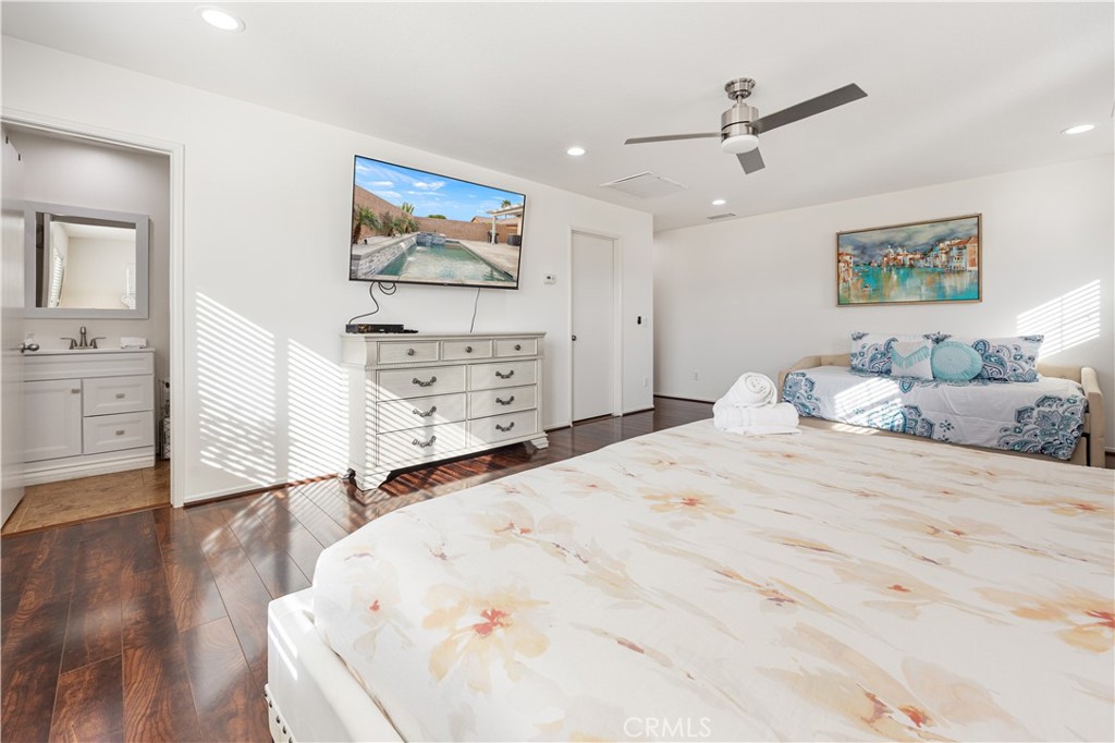 84155 Tramonto Way Indio, CA 92203 - Photo 22 of 38 a bedroom with a bed and wooden floor