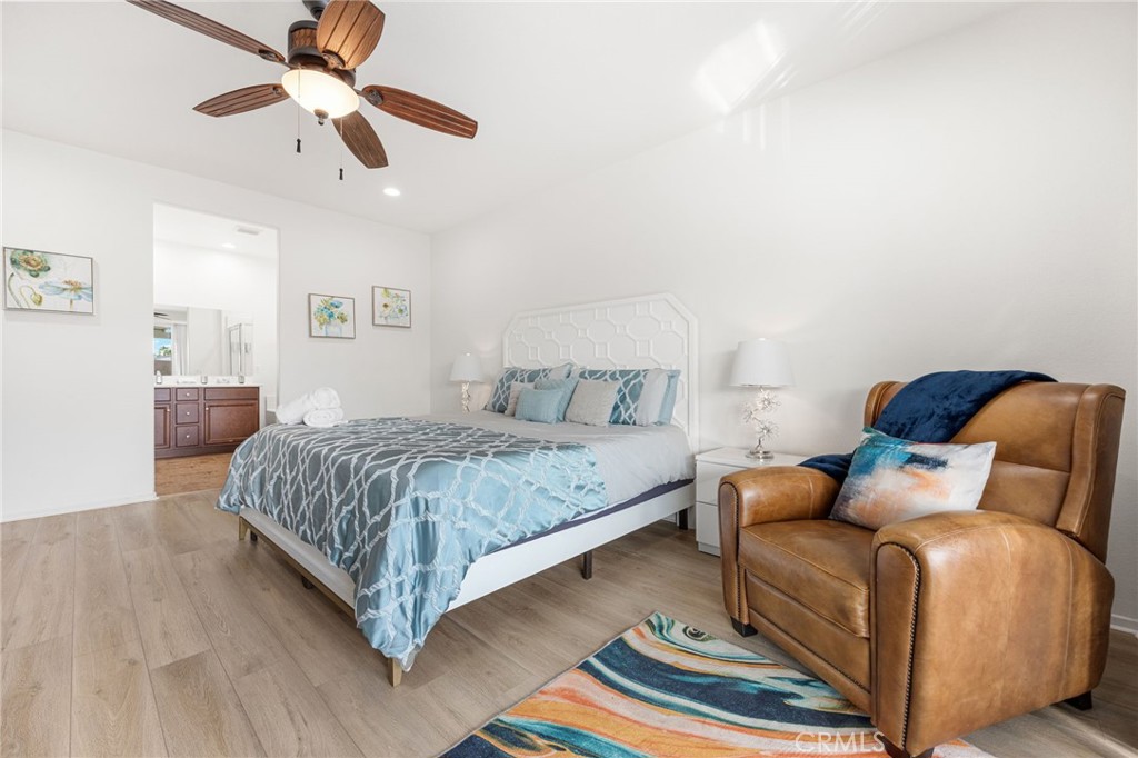 84155 Tramonto Way Indio, CA 92203 - Photo 34 of 38 a bedroom with a bed and a chandelier