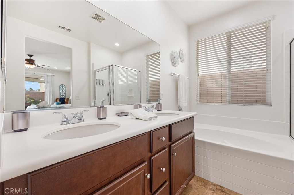 84155 Tramonto Way Indio, CA 92203 - Photo 36 of 38 a bathroom with a tub sink and mirror