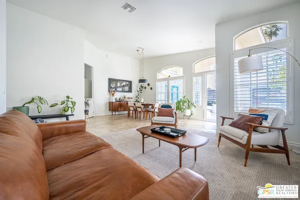 a living room with furniture and a potted plant