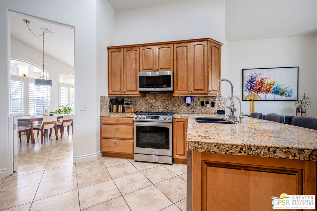 68210 Bella Vista Road Cathedral City, CA 92234 - Photo 11 of 47 a kitchen with a cabinets and a stove top oven