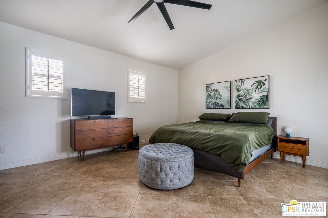 68210 Bella Vista Road Cathedral City, CA 92234 - Photo 16 of 47 a bedroom with furniture and a flat screen tv