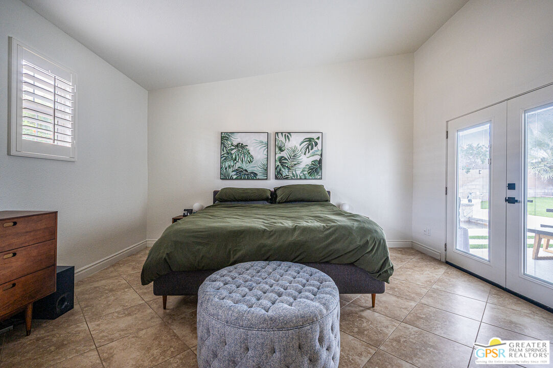 68210 Bella Vista Road Cathedral City, CA 92234 - Photo 17 of 47 a bedroom with a bed and a painting on the wall