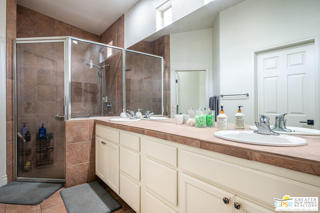 68210 Bella Vista Road Cathedral City, CA 92234 - Photo 19 of 47 a bathroom with a double vanity sink mirror and shower