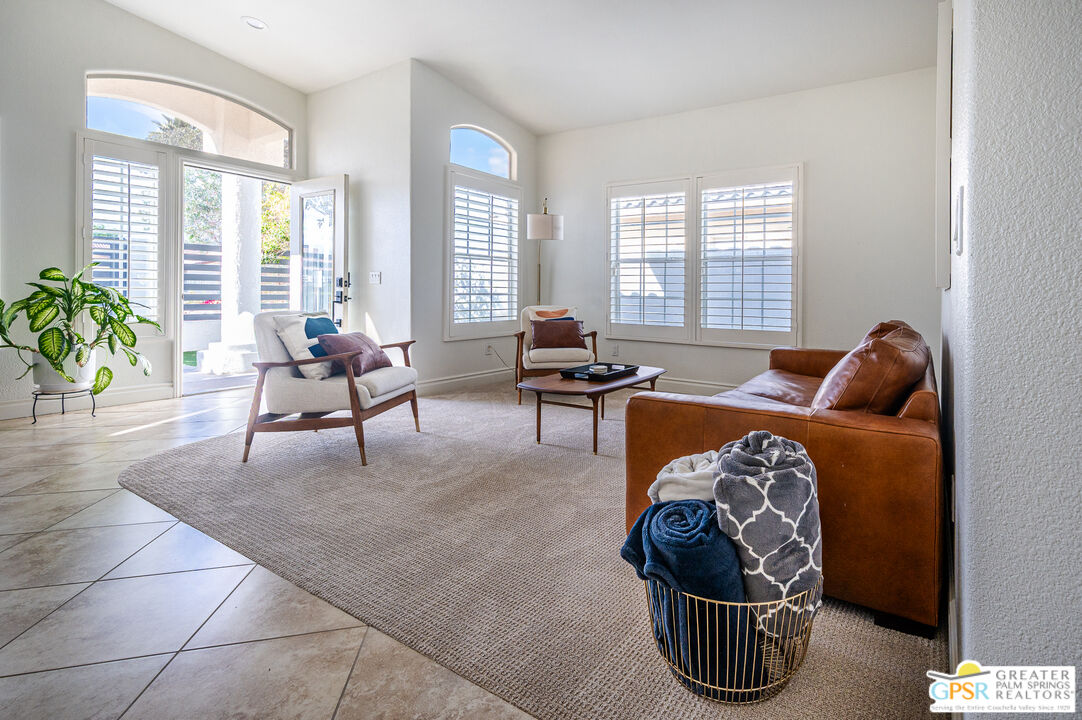 68210 Bella Vista Road Cathedral City, CA 92234 - Photo 2 of 47 a living room with furniture and floor to ceiling windows