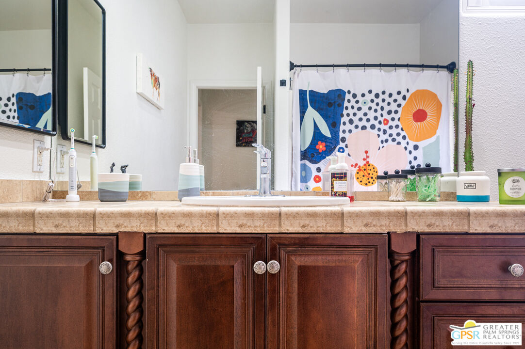 68210 Bella Vista Road Cathedral City, CA 92234 - Photo 26 of 47 a bathroom with granite countertop a sink and a mirror