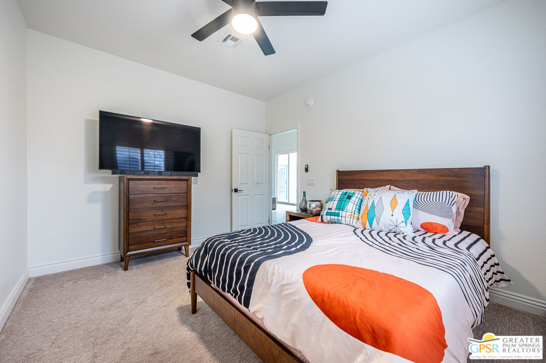 68210 Bella Vista Road Cathedral City, CA 92234 - Photo 28 of 47 a bedroom with a bed and a television