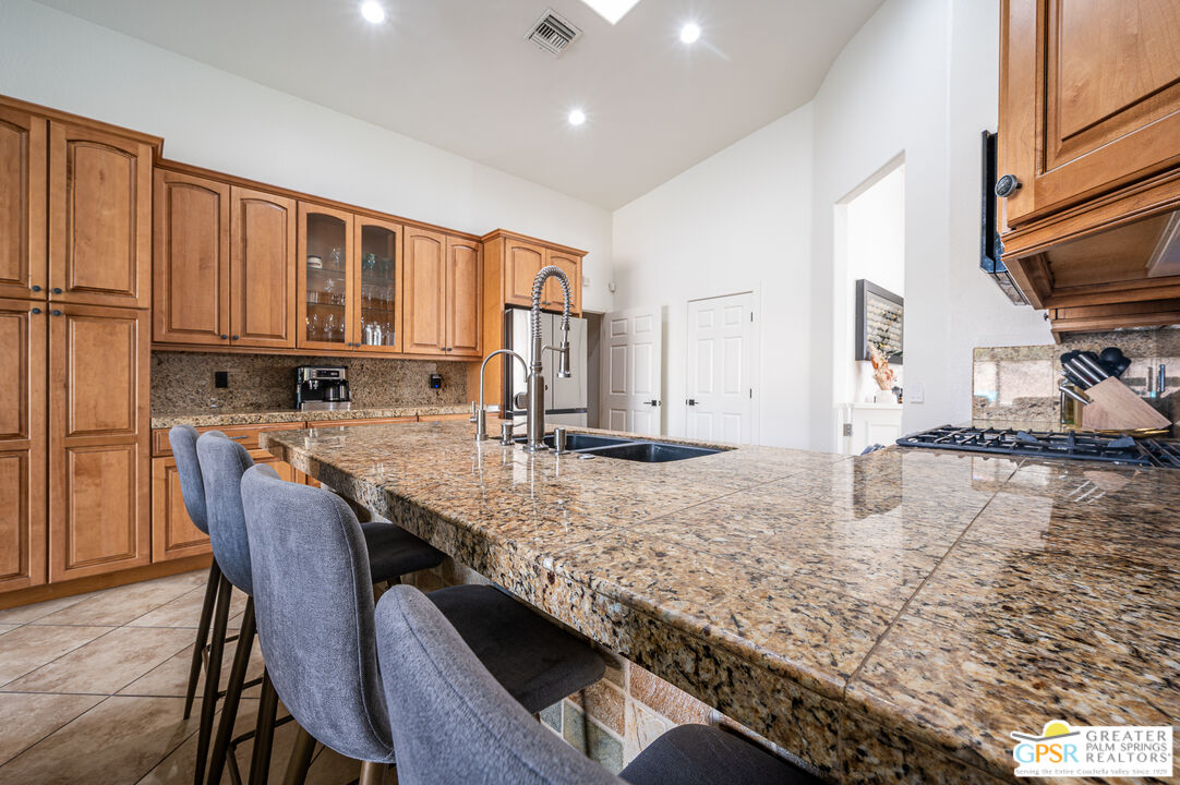 68210 Bella Vista Road Cathedral City, CA 92234 - Photo 8 of 47 a kitchen with stainless steel appliances granite countertop a stove a sink and a refrigerator