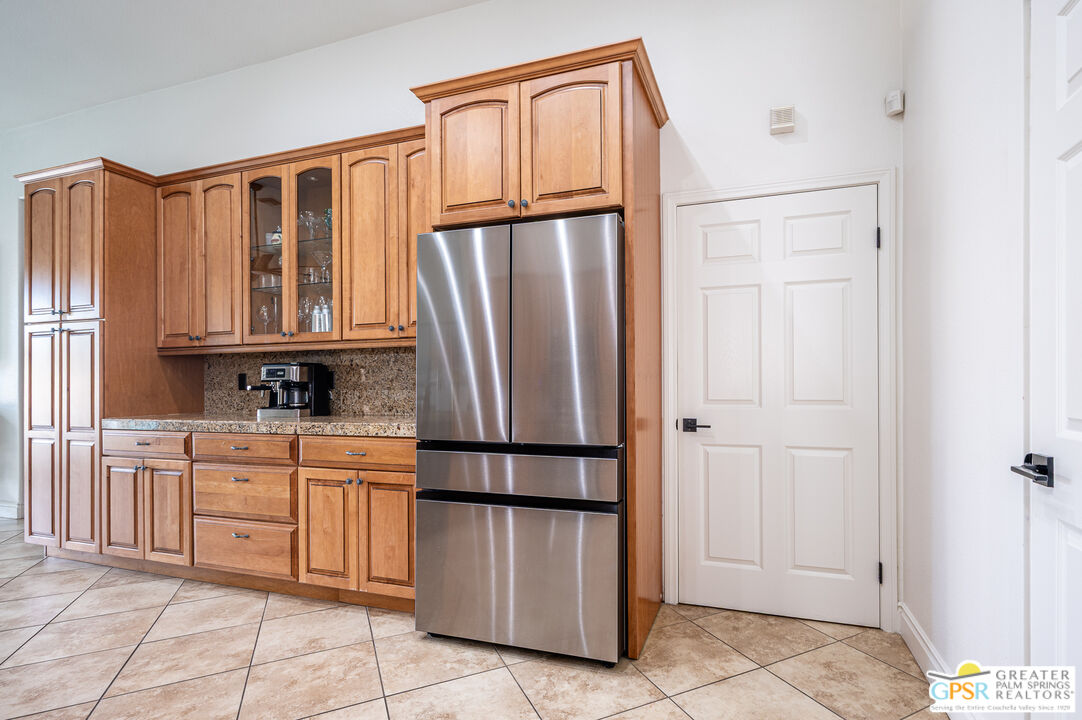 68210 Bella Vista Road Cathedral City, CA 92234 - Photo 10 of 47 a kitchen with stainless steel appliances granite countertop a refrigerator and a stove top oven