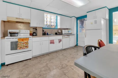 a kitchen with a refrigerator and a stove top oven