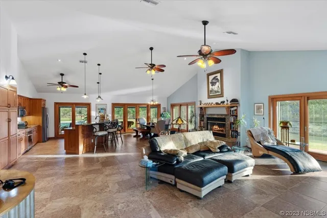 a living room with furniture gym equipment and large windows