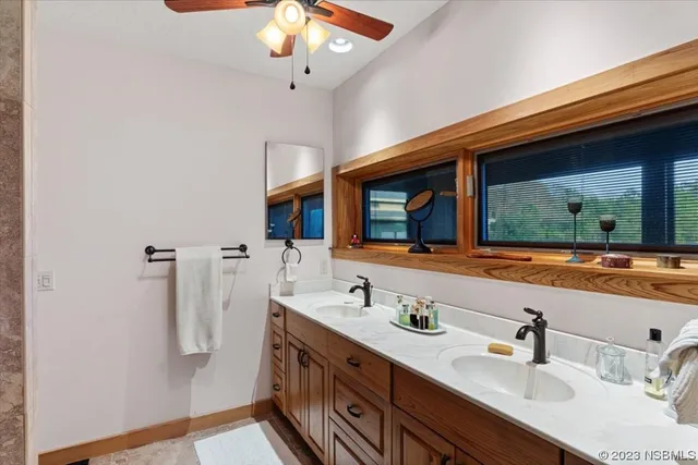 a bathroom with a double vanity sink and a mirror