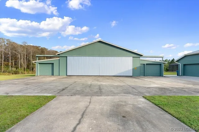 a front view of a house with a garage and a yard