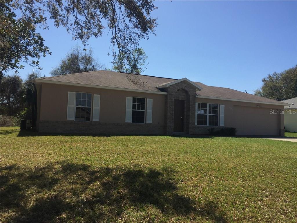 1939 Concert Road Deltona, FL 32738 - Photo 1 of 1 a house that has a tree in front of it
