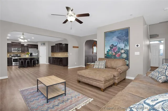 a living room with furniture and a chandelier