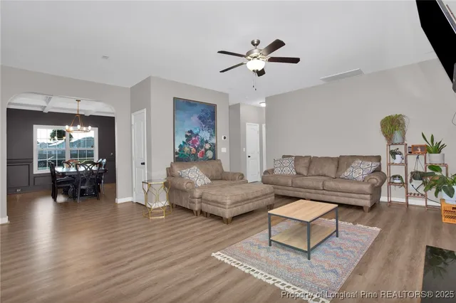 a living room with furniture and wooden floor