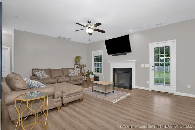 a living room with furniture a fireplace and a flat screen tv