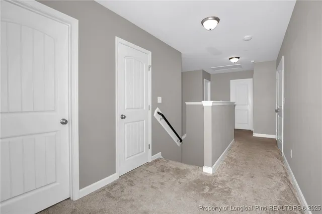an entryway space with white walls and stairs