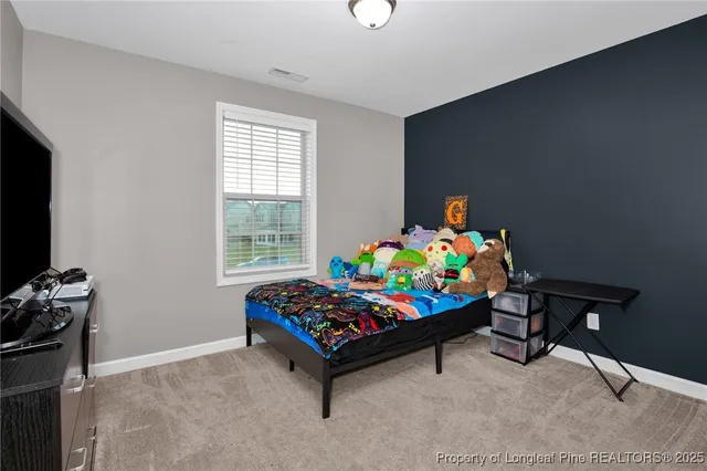 a bedroom with a bed and a desk