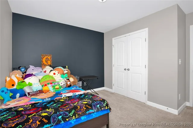 a bedroom with a bed and a dresser in it