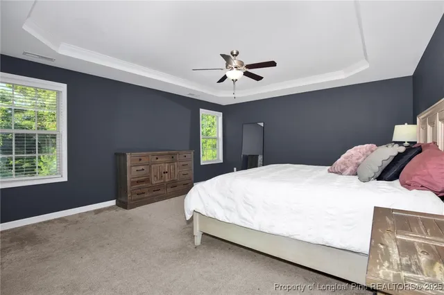 a bedroom with a bed dresser and a window