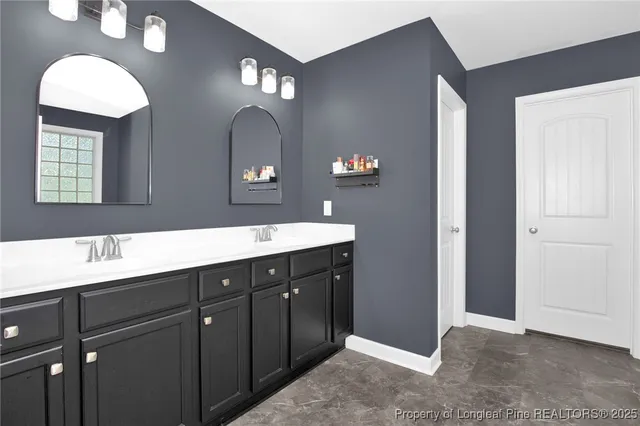 a bathroom with a double vanity sink and a mirror