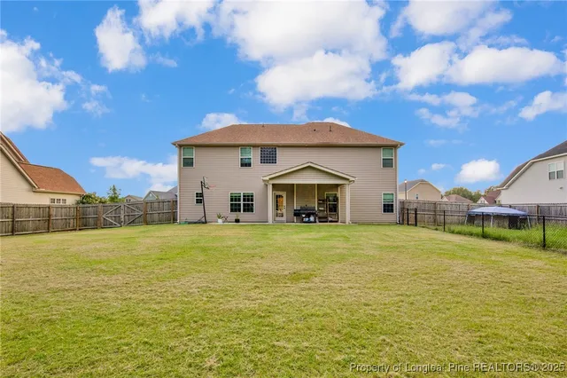 a front view of a house with a big yard
