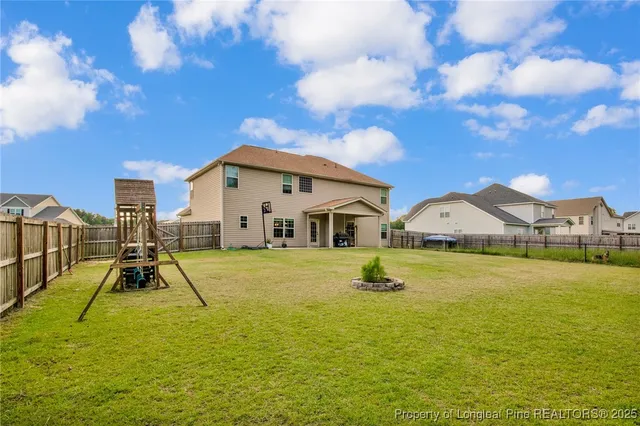 a view of a house with a yard and trees