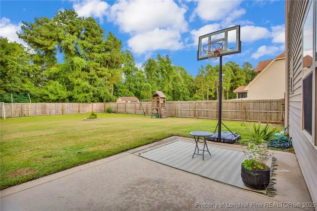 a view of a garden with a bench in front of house