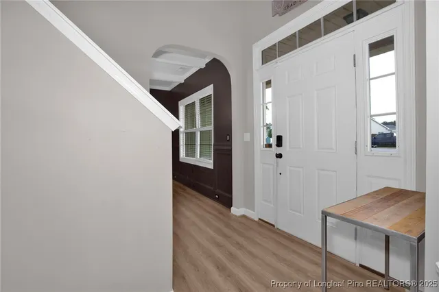 a view of a hallway with wooden floor and entryway