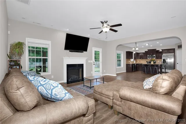 a living room with furniture fireplace and flat screen tv