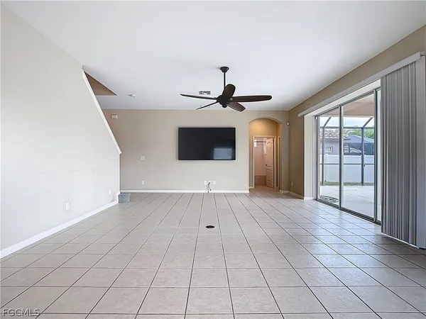 a view of a livingroom with a ceiling fan and window