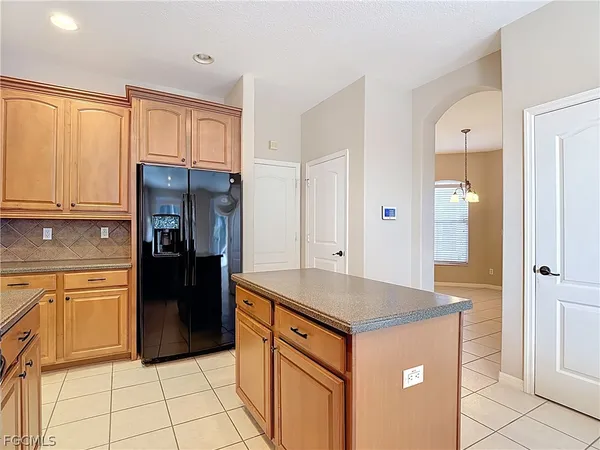 a kitchen with stainless steel appliances granite countertop a refrigerator and a stove